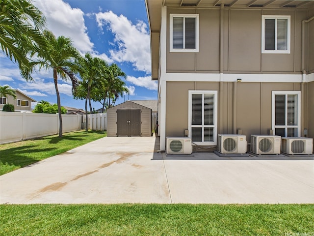 91-2037 Pahuhu Pl, Ewa Beach, HI 96706 - rear view of house with a storage unit, a patio, and board and batten siding