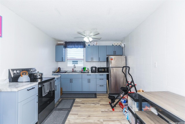 94-049 Waipahu St Unit 308, Waipahu, HI 96797 - kitchen with stainless steel appliances, light countertops, light wood-style flooring, ceiling fan, and backsplash