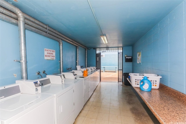 94-049 Waipahu St Unit 308, Waipahu, HI 96797 - shared laundry room featuring washer and clothes dryer and concrete block wall