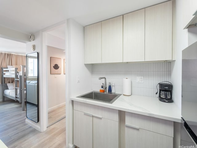 445 Seaside Ave Unit 720, Honolulu, HI 96815 - kitchen featuring light wood finished floors, backsplash, light stone countertops, and modern cabinets
