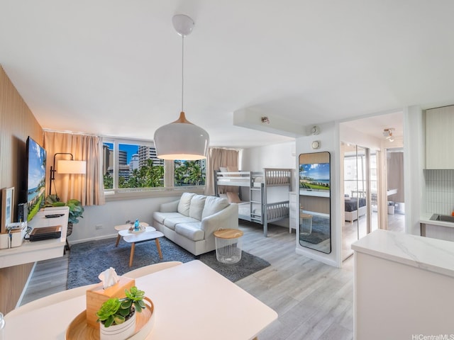 445 Seaside Ave Unit 720, Honolulu, HI 96815 - living room featuring light wood-style flooring and healthy amount of natural light