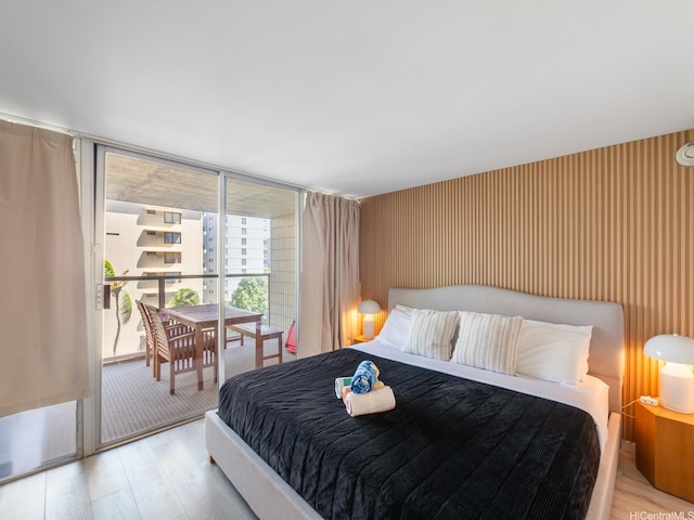 445 Seaside Ave Unit 720, Honolulu, HI 96815 - bedroom with wood finished floors, access to exterior, and expansive windows