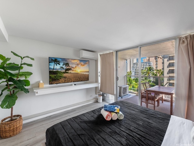 445 Seaside Ave Unit 720, Honolulu, HI 96815 - bedroom with an AC wall unit, wood finished floors, access to outside, and expansive windows