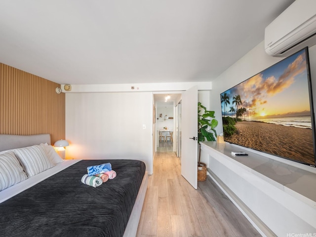 445 Seaside Ave Unit 720, Honolulu, HI 96815 - bedroom featuring a wall unit AC and light wood-style flooring