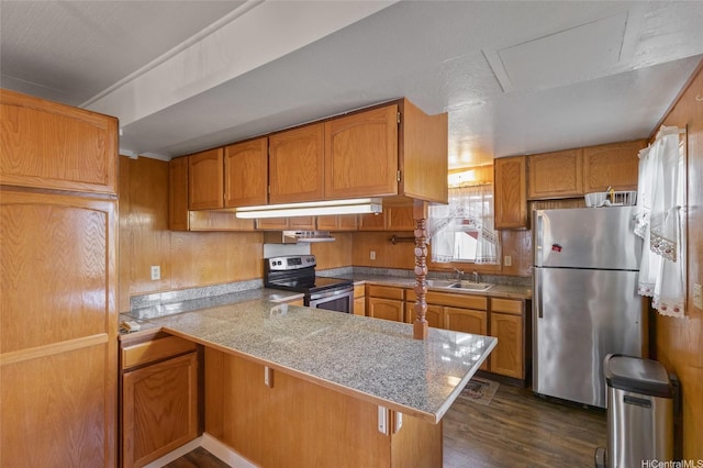67-186 Kanoena St, Waialua, HI 96791 - kitchen featuring stainless steel appliances, dark wood finished floors, a peninsula, brown cabinets, and under cabinet range hood