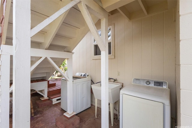 67-186 Kanoena St, Waialua, HI 96791 - laundry area with wooden walls and washing machine and clothes dryer
