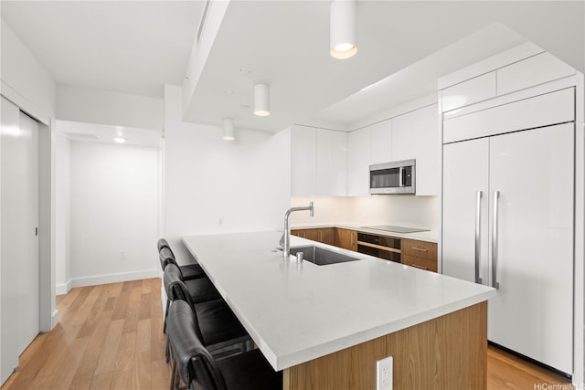 629 Keeaumoku St Unit 2212, Honolulu, HI 96814 - kitchen featuring black appliances, modern cabinets, light countertops, and light wood finished floors
