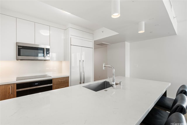 629 Keeaumoku St Unit 2212, Honolulu, HI 96814 - kitchen with stainless steel microwave, wall oven, paneled refrigerator, and modern cabinets