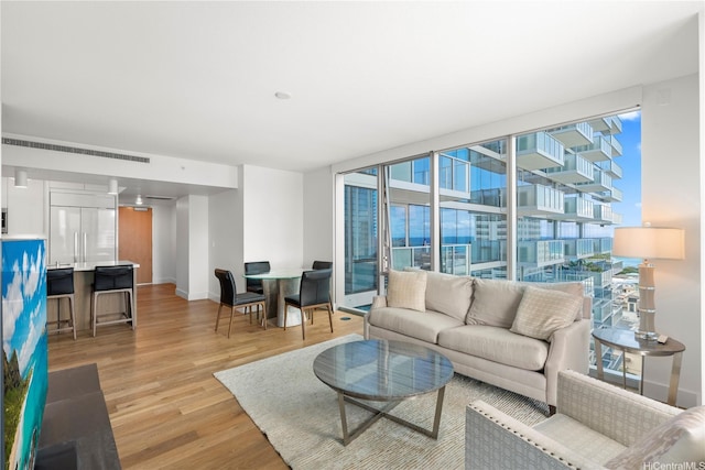 629 Keeaumoku St Unit 2212, Honolulu, HI 96814 - living room featuring light wood-type flooring and a wall of windows