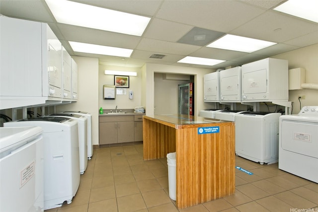 440 Olohana St Unit 1705, Honolulu, HI 96815 - laundry room with washing machine and clothes dryer and light tile patterned floors