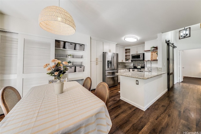 585 Mananai Pl Unit 26U, Honolulu, HI 96818 - kitchen with stainless steel appliances, open shelves, dark wood-type flooring, a peninsula, and white cabinets