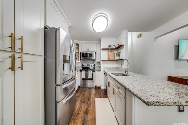 585 Mananai Pl Unit 26U, Honolulu, HI 96818 - kitchen with appliances with stainless steel finishes, open shelves, a peninsula, white cabinetry, and dark wood-style floors