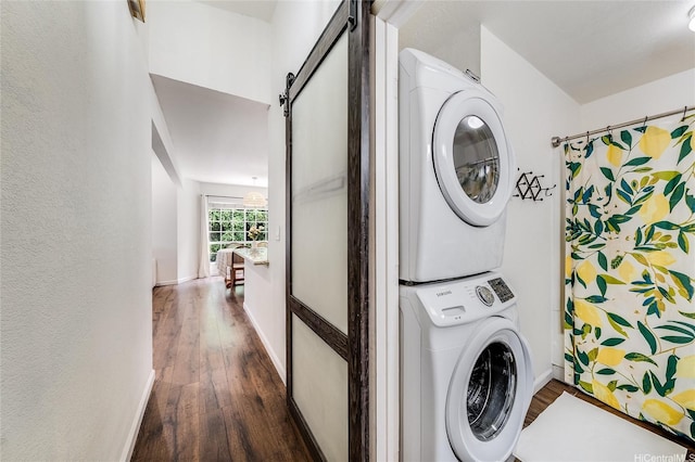 585 Mananai Pl Unit 26U, Honolulu, HI 96818 - laundry room featuring stacked washer / drying machine, dark wood-style flooring, a barn door, and a textured wall