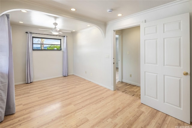4134 Likini St, Honolulu, HI 96818 - empty room with arched walkways, crown molding, light wood finished floors, a smoke detector, and ceiling fan