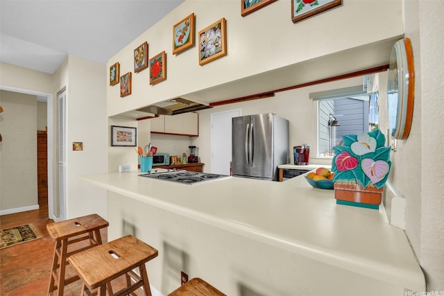 94-517 Poloahilani St, Mililani, HI 96789 - kitchen featuring appliances with stainless steel finishes, a kitchen breakfast bar, light countertops, and a peninsula