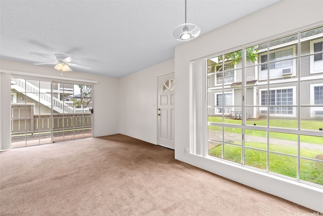 94-1369 Kulewa Loop Unit 14B, Waipahu, HI 96797 - unfurnished living room featuring carpet, ceiling fan, and a textured ceiling