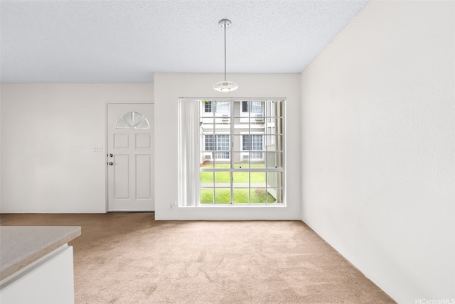94-1369 Kulewa Loop Unit 14B, Waipahu, HI 96797 - unfurnished dining area featuring carpet floors and a textured ceiling