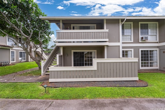 94-1369 Kulewa Loop Unit 14B, Waipahu, HI 96797 - view of front of home with stairs, a balcony, a front yard, and stucco siding