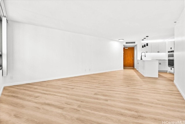 1330 Ala Moana Blvd Unit 1907, Honolulu, HI 96814 - unfurnished living room featuring light wood-style flooring and baseboards