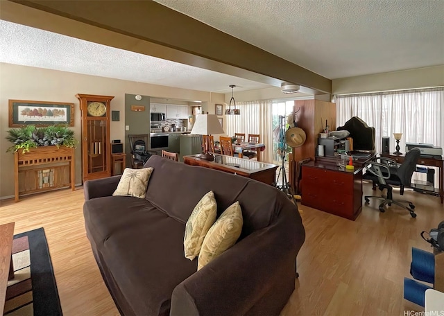 320 Ainakea Way Unit 812, Honolulu, HI 96815 - living room featuring a desk, light wood-style floors, and a textured ceiling