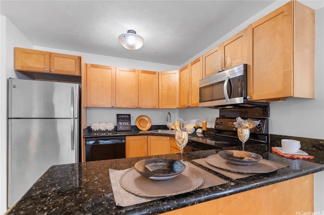 430 Kaiolu St Unit 505, Honolulu, HI 96815 - kitchen featuring black appliances, dark stone countertops, and light brown cabinetry
