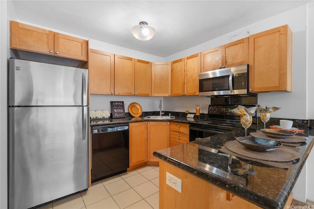 430 Kaiolu St Unit 505, Honolulu, HI 96815 - kitchen with black appliances, dark stone countertops, a peninsula, and light tile patterned flooring