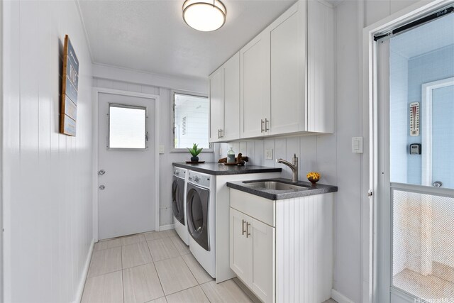 46-146 Hinalani Pl, Kaneohe, HI 96744 - washroom featuring washing machine and dryer, cabinet space, and light tile patterned floors