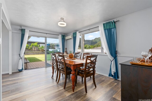 46-146 Hinalani Pl, Kaneohe, HI 96744 - dining space with wood finished floors and a wall mounted AC