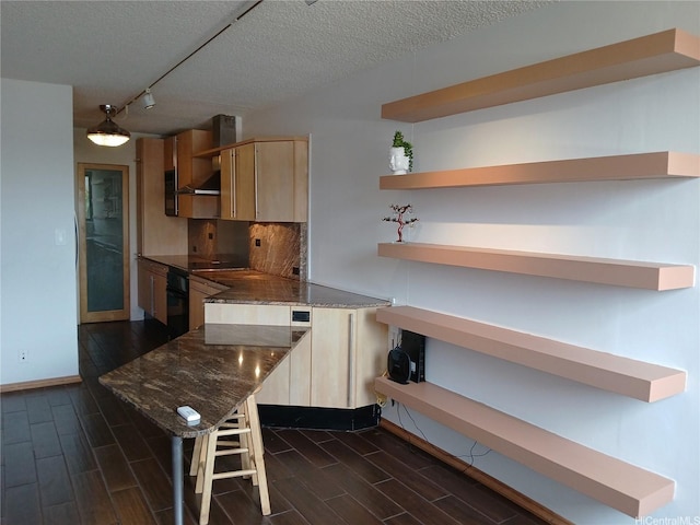 2092 Kuhio Ave Unit 805, Honolulu, HI 96815 - kitchen featuring open shelves, wall chimney exhaust hood, oven, light brown cabinetry, and wood finish floors