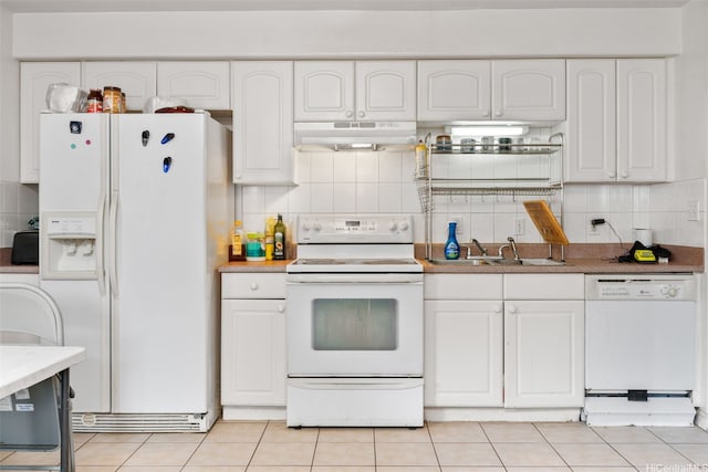 1607 Makiki St Unit B, Honolulu, HI 96822 - kitchen featuring white appliances, under cabinet range hood, white cabinetry, tasteful backsplash, and light tile patterned flooring