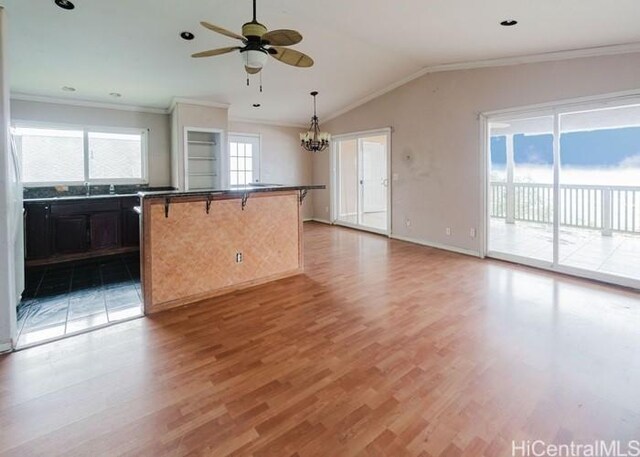 73-4154 Kahauli Pl, Kailua Kona, HI 96740 - kitchen with light wood-type flooring, a ceiling fan, a chandelier, ornamental molding, and lofted ceiling
