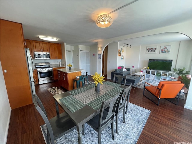 475 Atkinson Dr Unit 1909, Honolulu, HI 96814 - dining room featuring arched walkways and dark wood-style flooring
