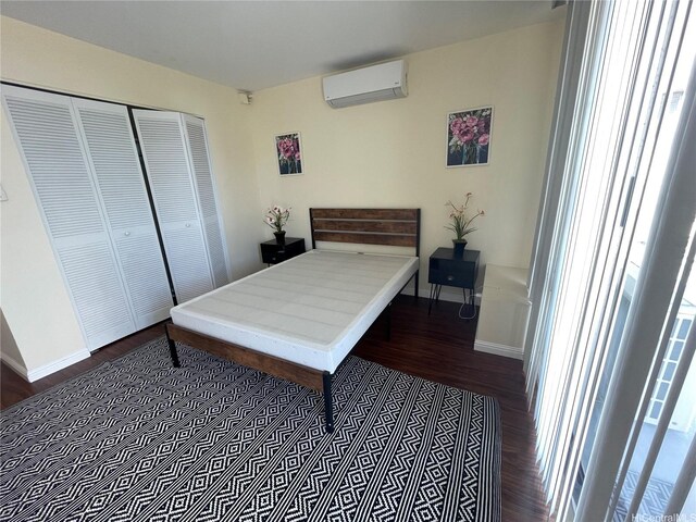 475 Atkinson Dr Unit 1909, Honolulu, HI 96814 - bedroom with wood finished floors, a wall mounted air conditioner, and a closet