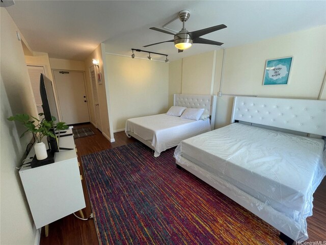 475 Atkinson Dr Unit 1909, Honolulu, HI 96814 - bedroom with wood finished floors, rail lighting, and a ceiling fan