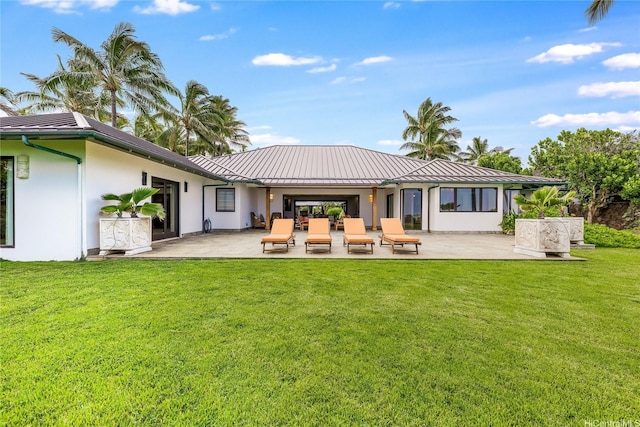 47 Kailuana Pl, Kailua, HI 96734 - back of property with a patio, stucco siding, a standing seam roof, and a yard