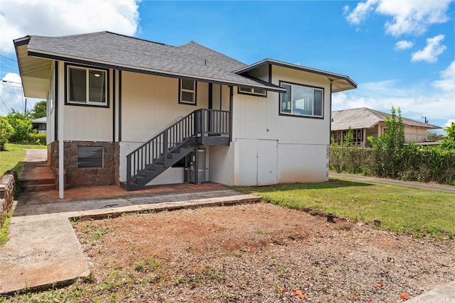 115A Makaweo St, Wahiawa, HI 96786 - rear view of house with a lawn and roof with shingles