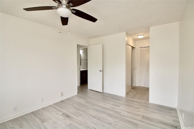 91-1180 Puamaeole St Unit 10T, Ewa Beach, HI 96706 - unfurnished bedroom featuring light wood-type flooring, a textured ceiling, and a ceiling fan