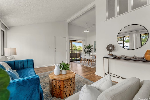 95-138 Kuahelani Ave Unit 244, Mililani, HI 96789 - living room with wood finished floors, a textured ceiling, high vaulted ceiling, and beam ceiling