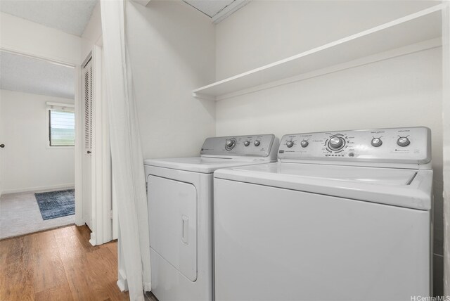 95-138 Kuahelani Ave Unit 244, Mililani, HI 96789 - washroom featuring light wood finished floors and washing machine and dryer
