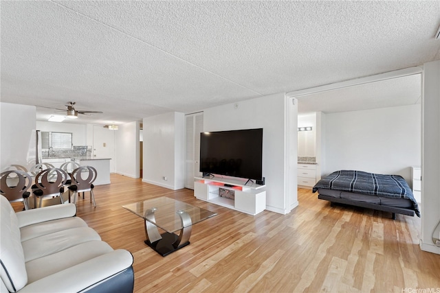 469 Ena Rd Unit 1111, Honolulu, HI 96815 - living area with light wood-style flooring, a textured ceiling, and ceiling fan