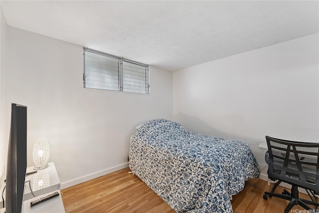 469 Ena Rd Unit 1111, Honolulu, HI 96815 - bedroom featuring baseboards and wood finished floors