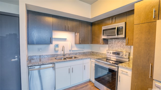 988 Halekauwila St Unit 4108, Honolulu, HI 96816 - kitchen featuring stainless steel appliances, light stone countertops, light wood-style floors, and white cabinetry
