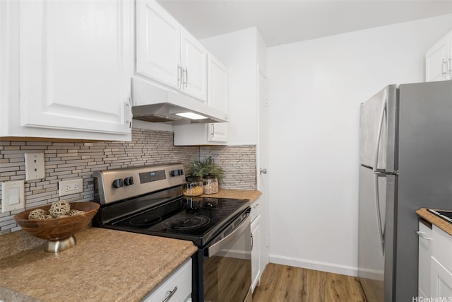 3370 Salt Lake Blvd Unit 204, Honolulu, HI 96818 - kitchen with appliances with stainless steel finishes, under cabinet range hood, light wood-type flooring, and white cabinetry