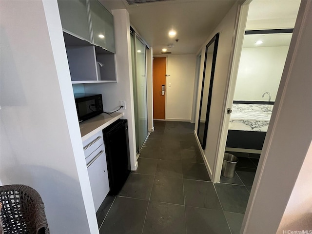 410 Atkinson Dr Unit 2007, Honolulu, HI 96814 - kitchen featuring black microwave, dark tile patterned floors, light countertops, and recessed lighting