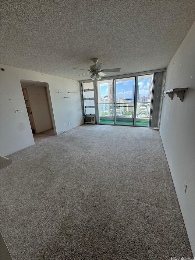1450 Young St Unit 2103, Honolulu, HI 96814 - empty room with ceiling fan, a textured ceiling, carpet, a wall of windows, and cooling unit