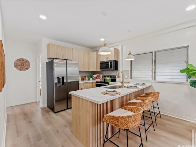 87-2204 Farrington Hwy Unit A, Waianae, HI 96792 - kitchen with stainless steel appliances, a peninsula, light brown cabinets, light wood-style flooring, and tasteful backsplash