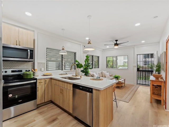 87-2204 Farrington Hwy Unit A, Waianae, HI 96792 - kitchen with appliances with stainless steel finishes, a peninsula, light countertops, ceiling fan, and tasteful backsplash