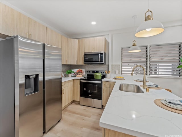 87-2204 Farrington Hwy Unit A, Waianae, HI 96792 - kitchen with stainless steel appliances, light brown cabinets, light stone countertops, backsplash, and pendant lighting