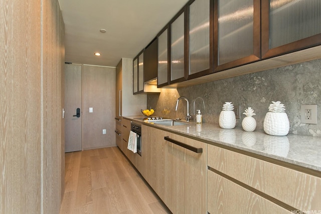 1000 Auahi St Unit 1805, Honolulu, HI 96814 - kitchen with light wood-style flooring, light stone counters, tasteful backsplash, glass insert cabinets, and recessed lighting