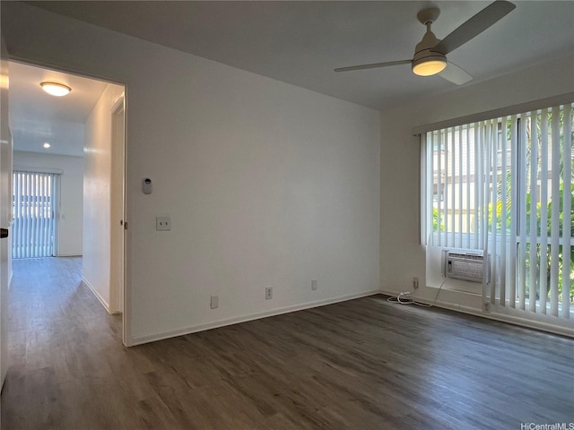 91-1089 Puamaeole St Unit 15D, Ewa Beach, HI 96706 - empty room with dark wood finished floors, a ceiling fan, and a wall unit AC